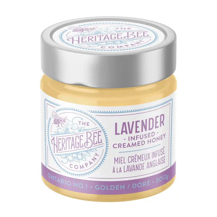 Jar of lavender-infused creamed honey from The Heritage Bee Company on a white background