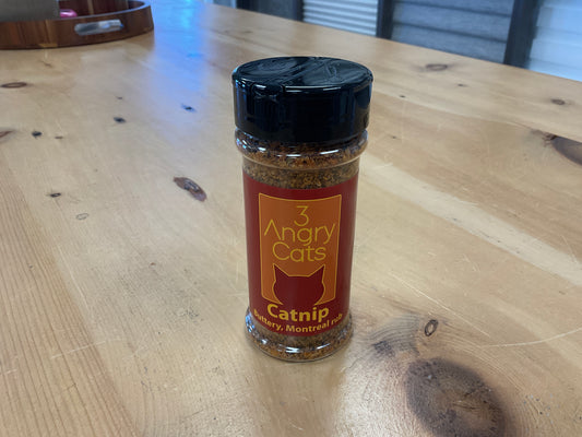Bottle of 3 Angry Cats catnip on a wooden table