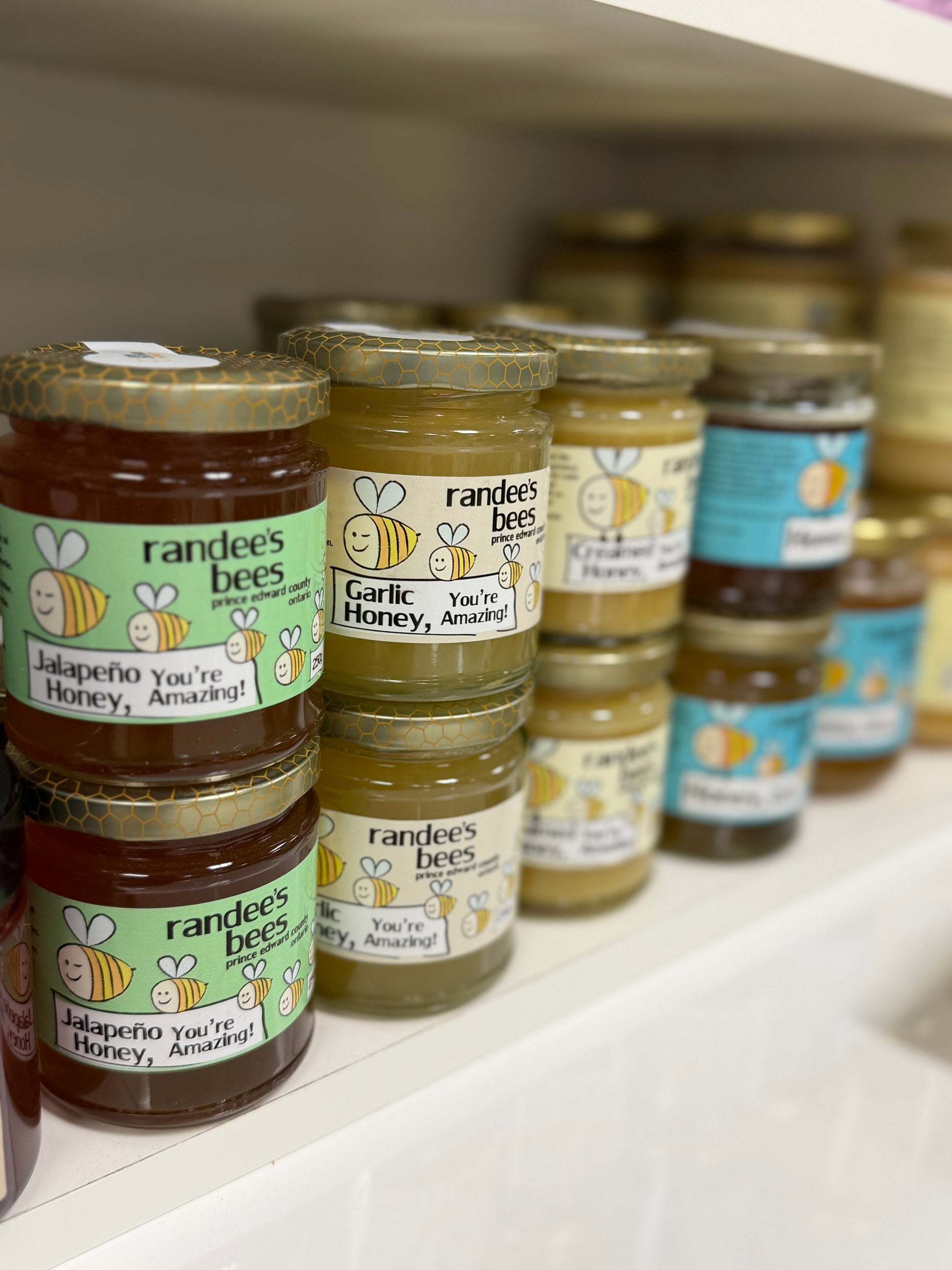 Jars of randee's bees honey on a shelf