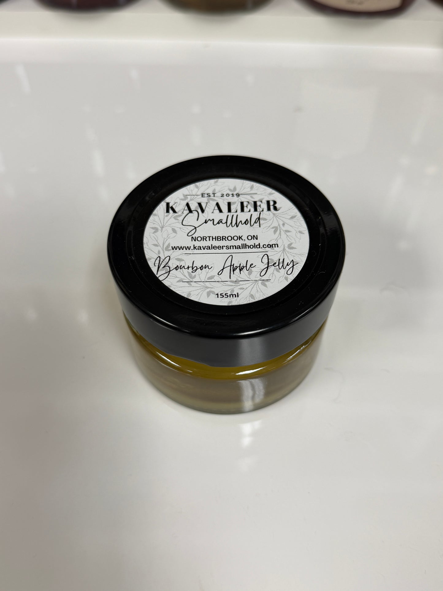Jar of Kavaleer Apple Bourbon on a white background