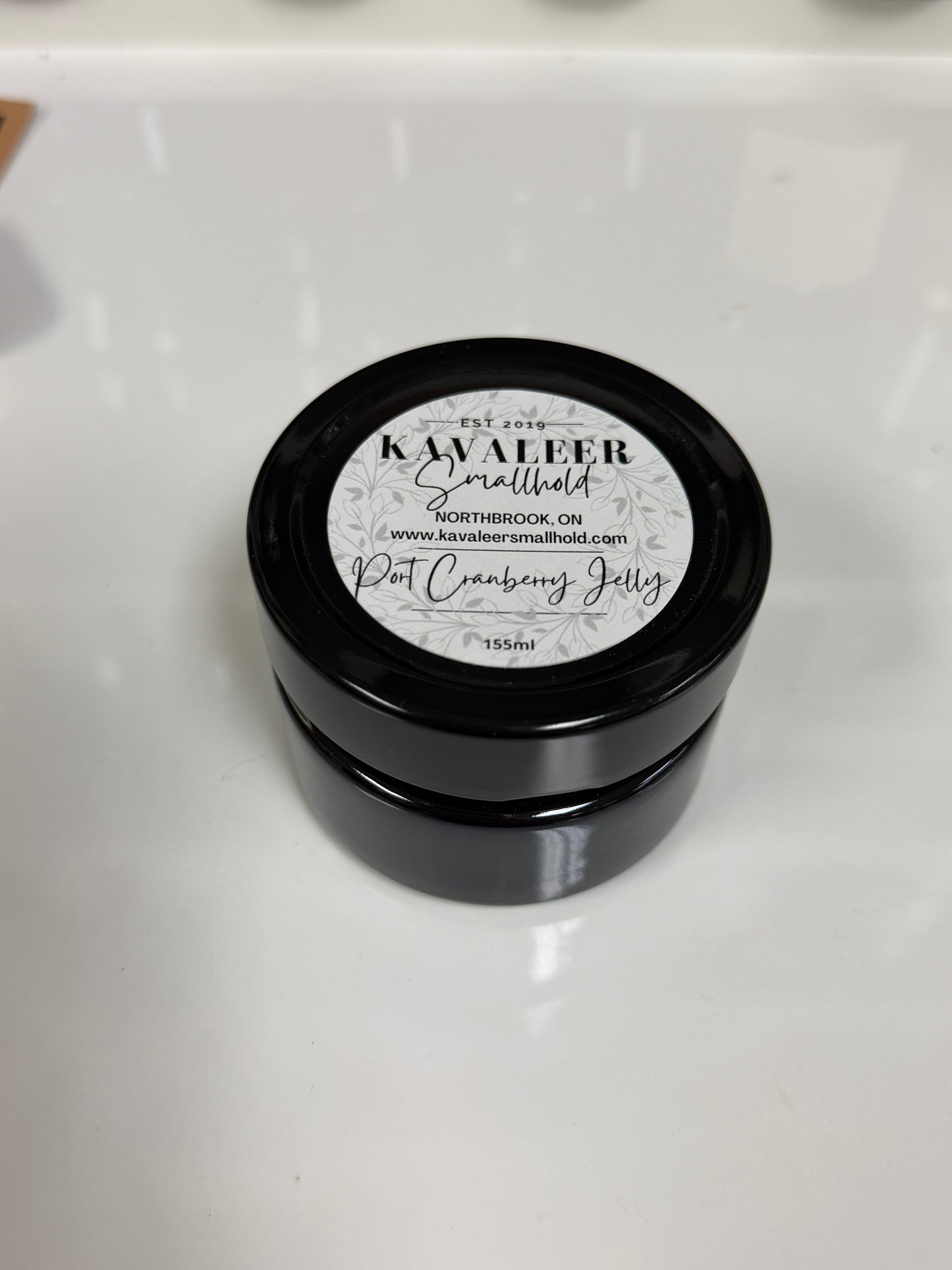 Black container of Kavaleer Port Cranberry Jelly on a white background