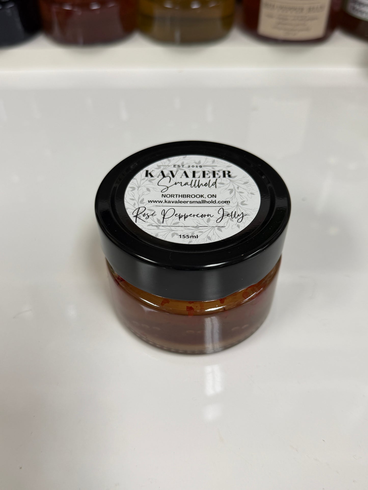 Jar of Kavaleer Rose Peppercorn on a white surface