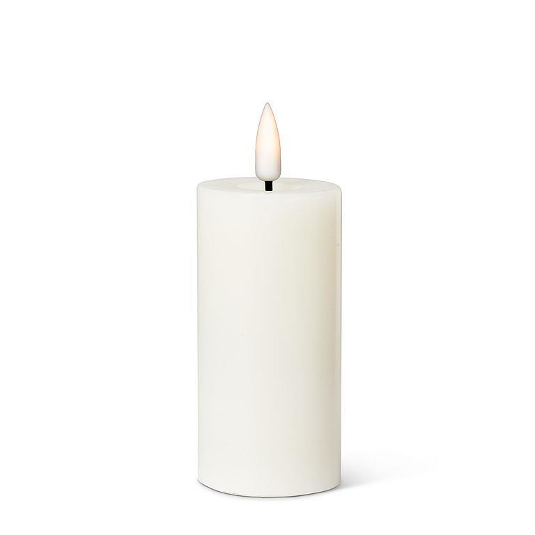Sand candle with a flame on a white background
