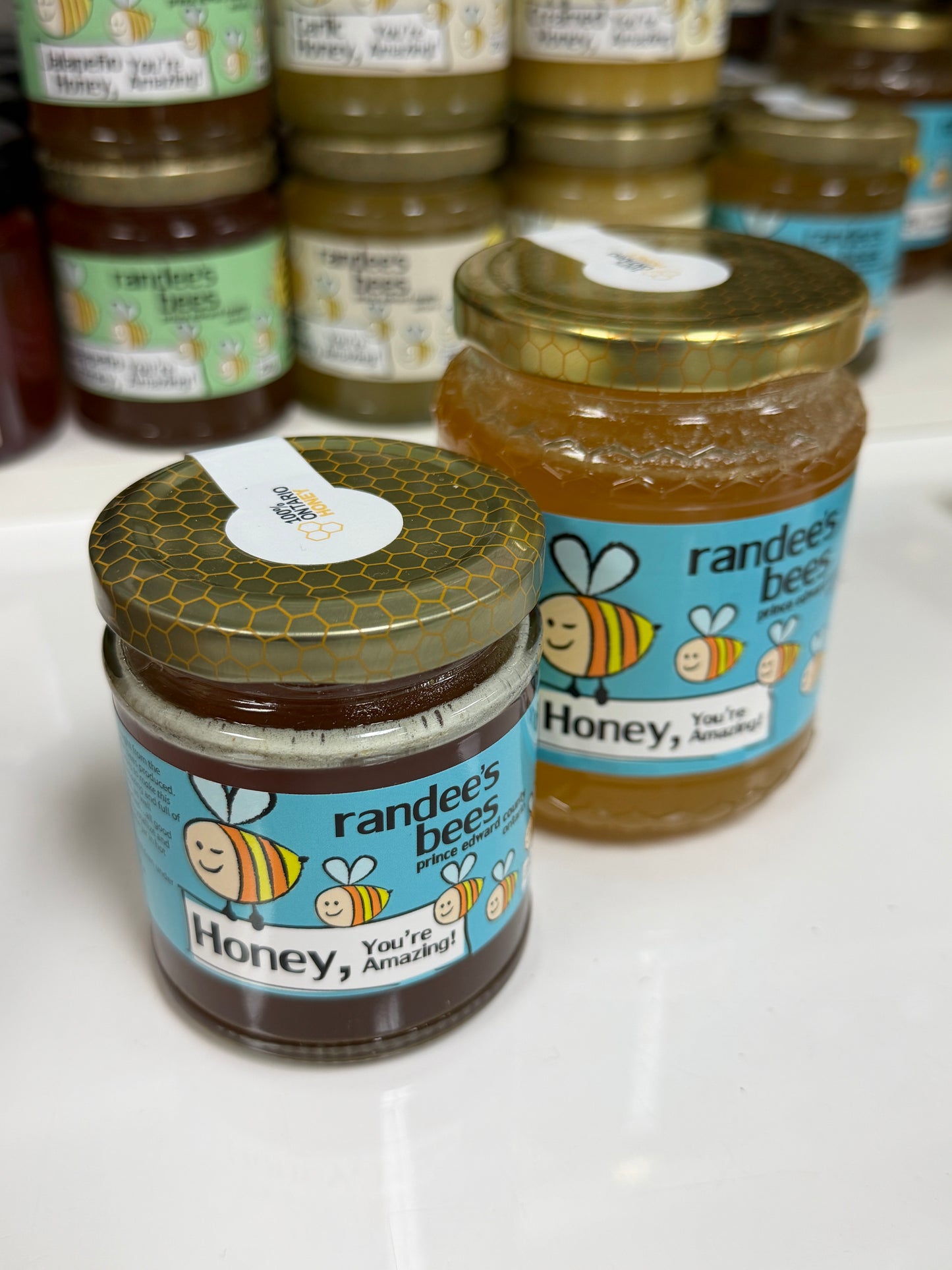 Jars of Randee's Bee Honey on a white surface