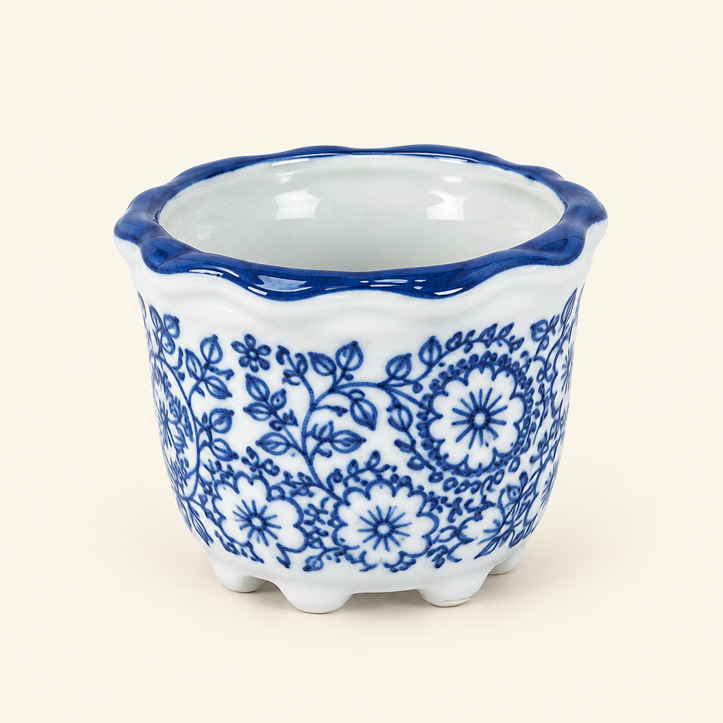 Single cobalt blue porcelain pot on a solid ivory background